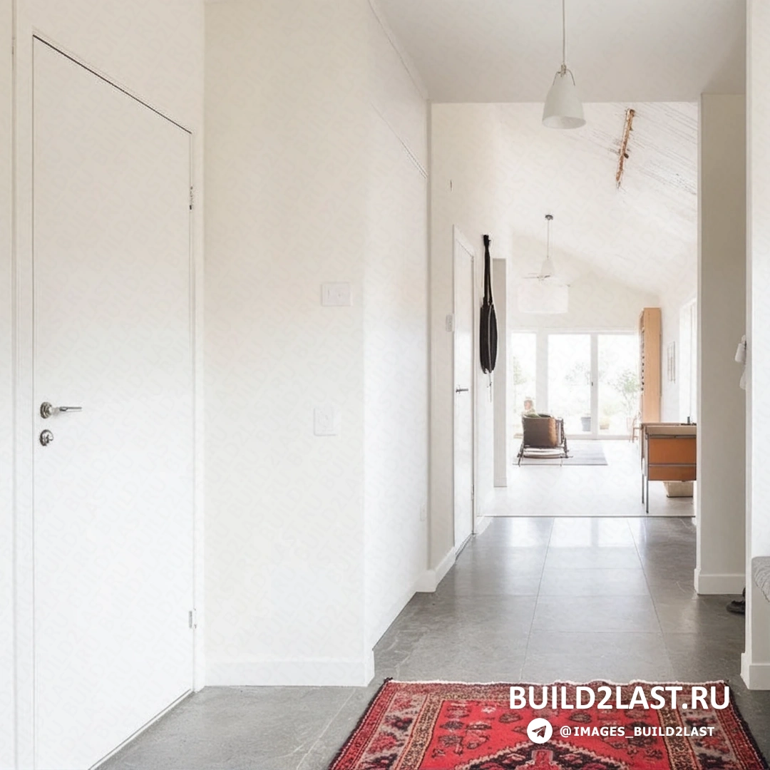 Кухня загородного дома Vallmo с мебелью и кухонной мойкой, оформленная в серых и белых тонах.